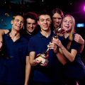 Team of excited teenage participants of e-sports video gaming competition