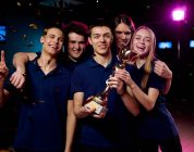 Team of excited teenage participants of e-sports video gaming competition