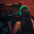 young girl playing game on computer, banner