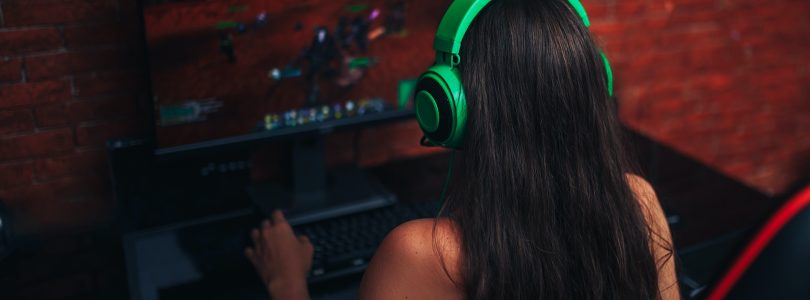 young girl playing game on computer, banner